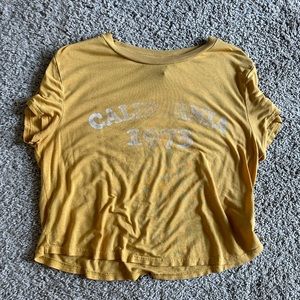 Mustard, yellow cropped tee shirt “California 1973”